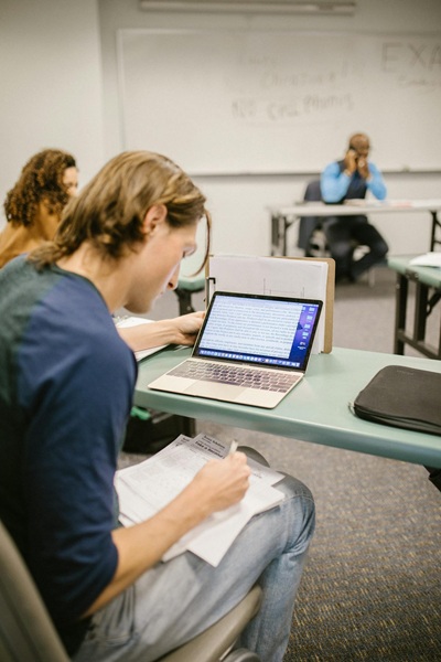 student at desk completing classroom task